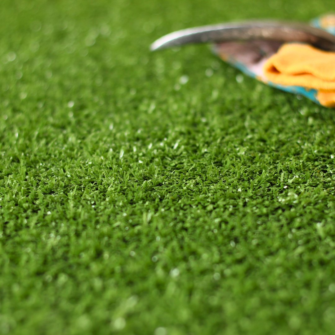 £1 coin placed by artificial grass to demonstrate texture and size.